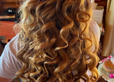 Stylish blonde curls showcased at Style Journey Hair Salon, Pretoria, Gauteng, ZA.