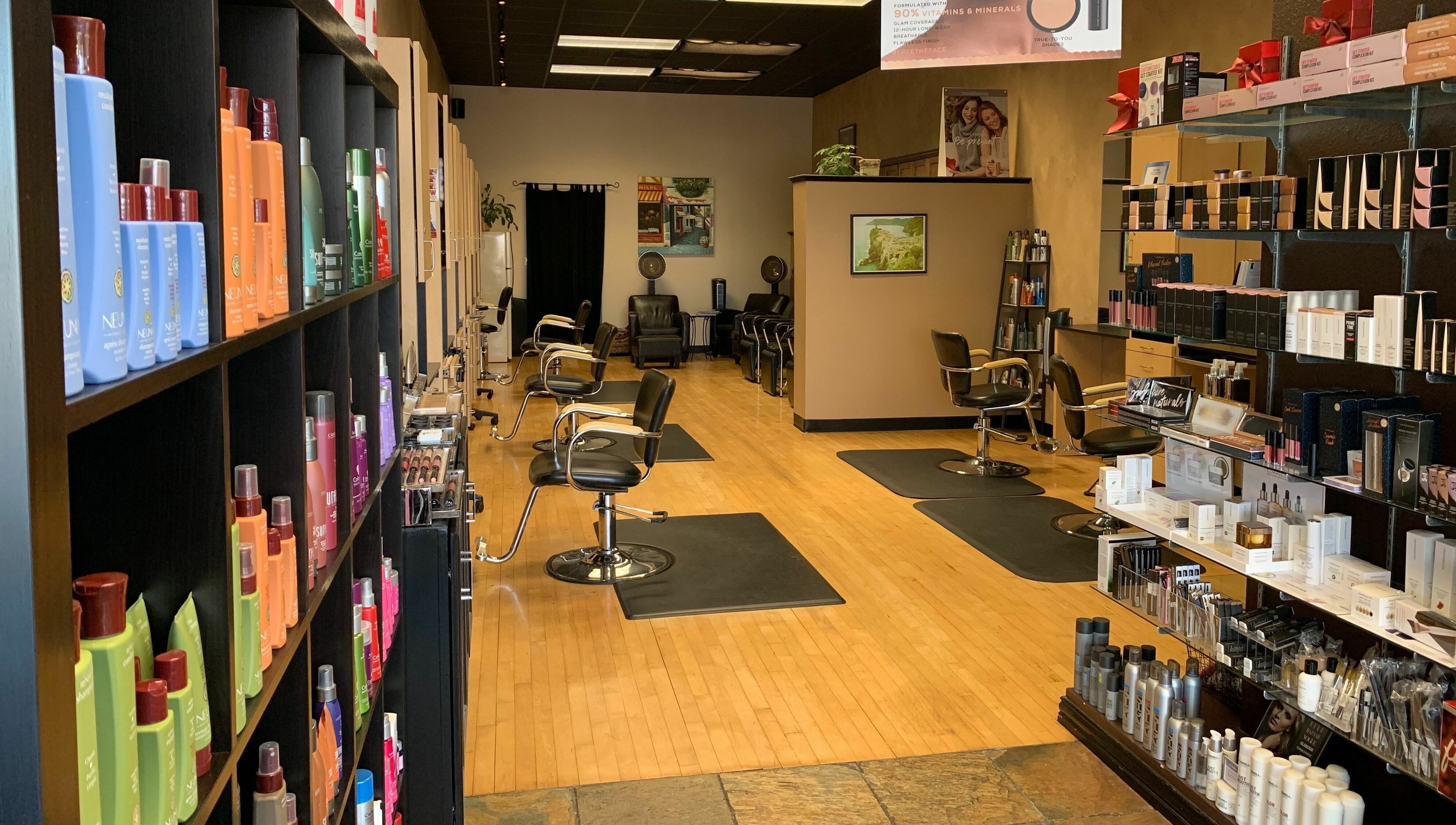 Interior view of Salone Di Essenza in Austin, Texas, US with stylish salon chairs and beauty products displayed.