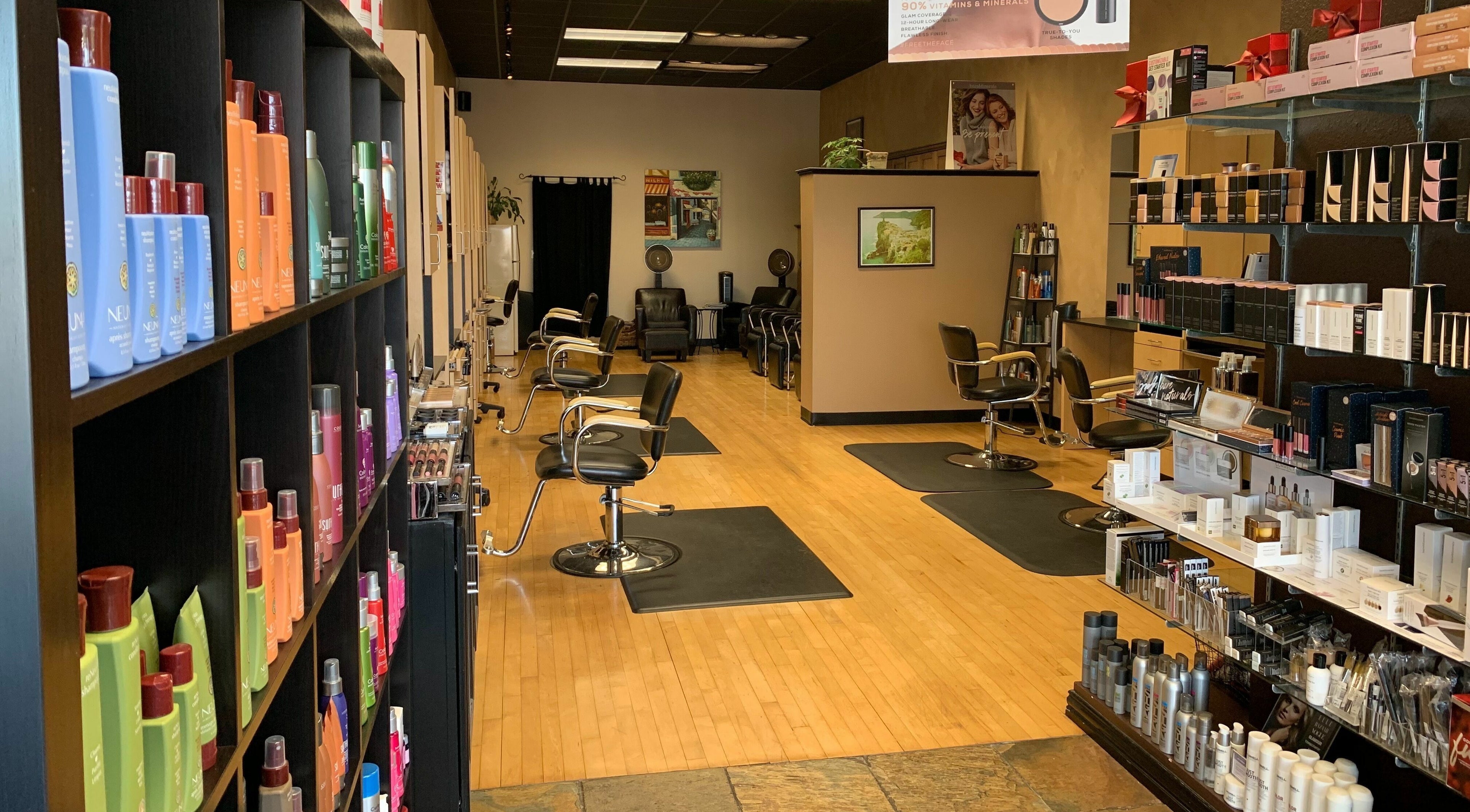 Interior view of Salone Di Essenza in Austin, Texas, US with stylish salon chairs and beauty products displayed.