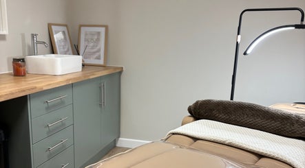 Peaceful treatment room at Miceli Beauty Studio, Waterlooville, England, GB featuring a cozy bed and sink.