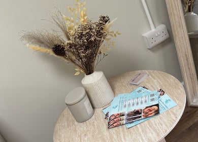 Elegant table with vase and brochures at Miceli Beauty Studio, Waterlooville, England, GB.