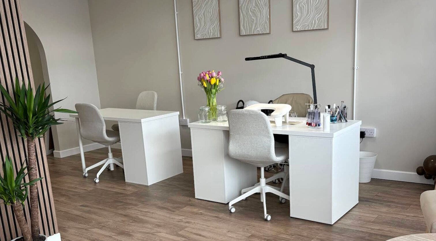 Elegant workspace at Miceli Beauty Studio, Waterlooville, England, GB with modern chairs and floral decor.