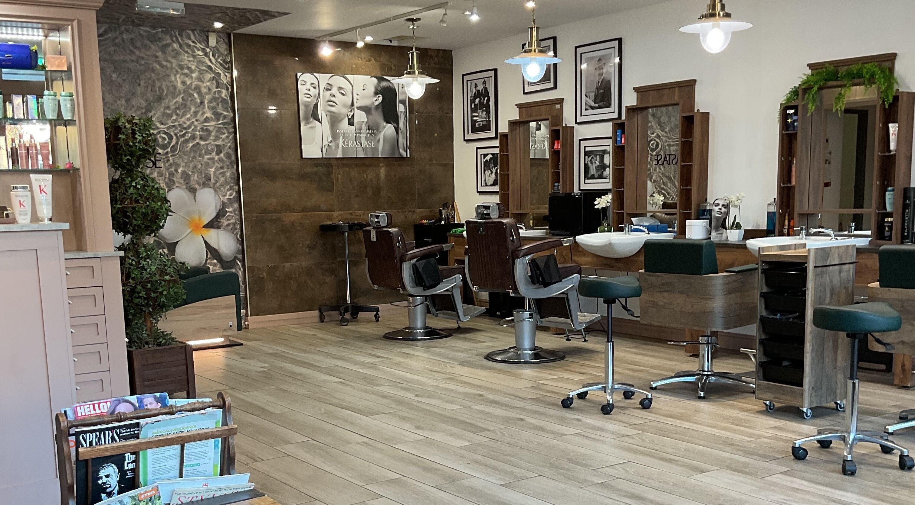 Stylish interior of The Hair Emporium (Whalley) with modern salon chairs in Whalley, England, GB.