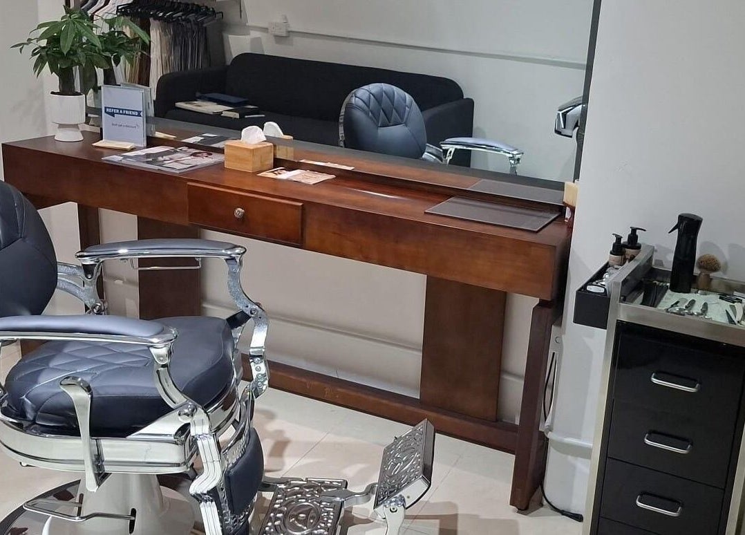 Luxurious barber chair at Barberia e Sartoria Italiana, Hong Kong Island, HK, showcasing elegance and comfort.