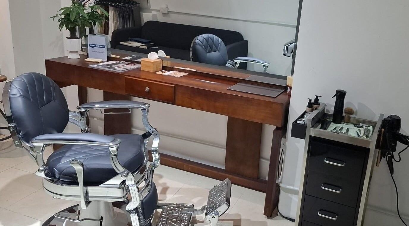 Luxurious barber chair at Barberia e Sartoria Italiana, Hong Kong Island, HK, showcasing elegance and comfort.