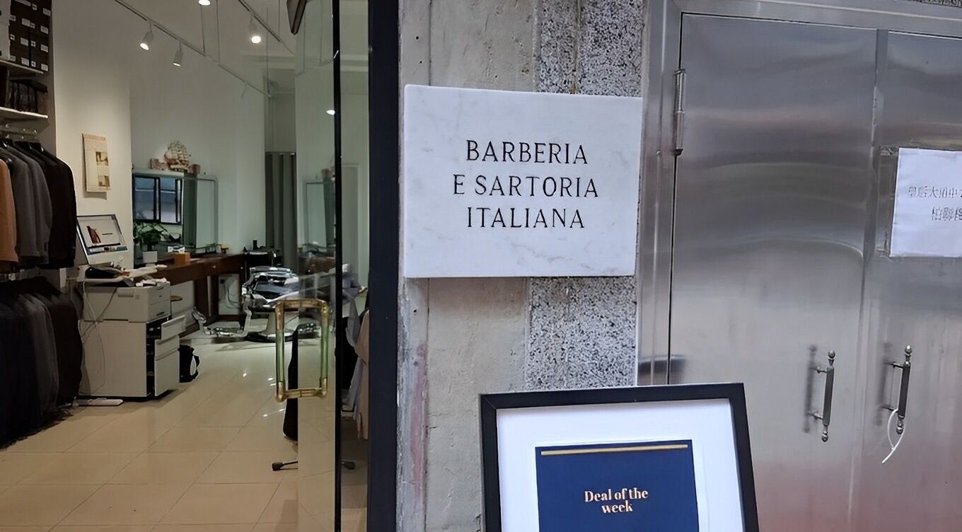 Entrance of Barberia e Sartoria Italiana on Hong Kong Island showcasing chic interior.
