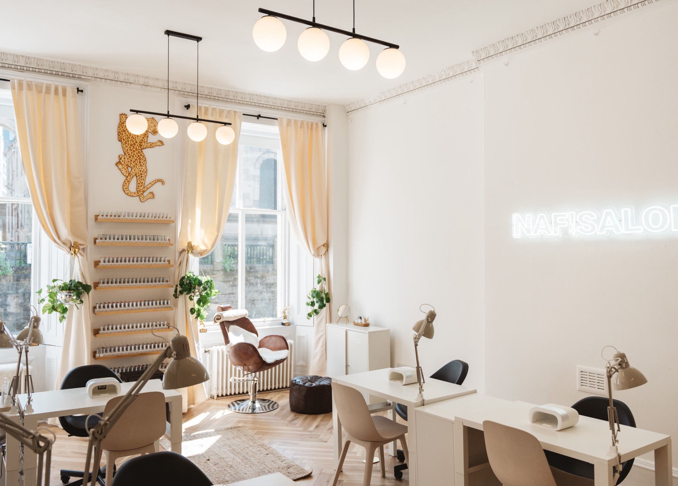 Bright, chic interior of Claws By Clayre salon in Glasgow, Scotland, GB with elegant decor and nail stations.