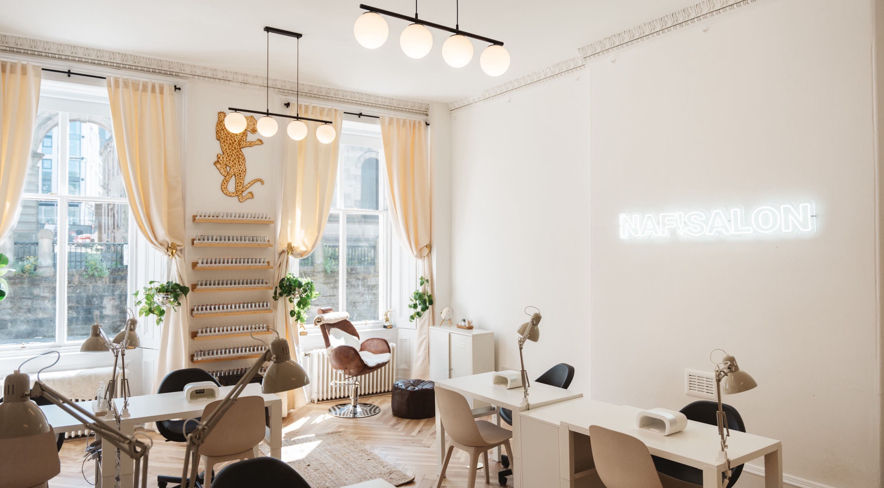 Bright, chic interior of Claws By Clayre salon in Glasgow, Scotland, GB with elegant decor and nail stations.