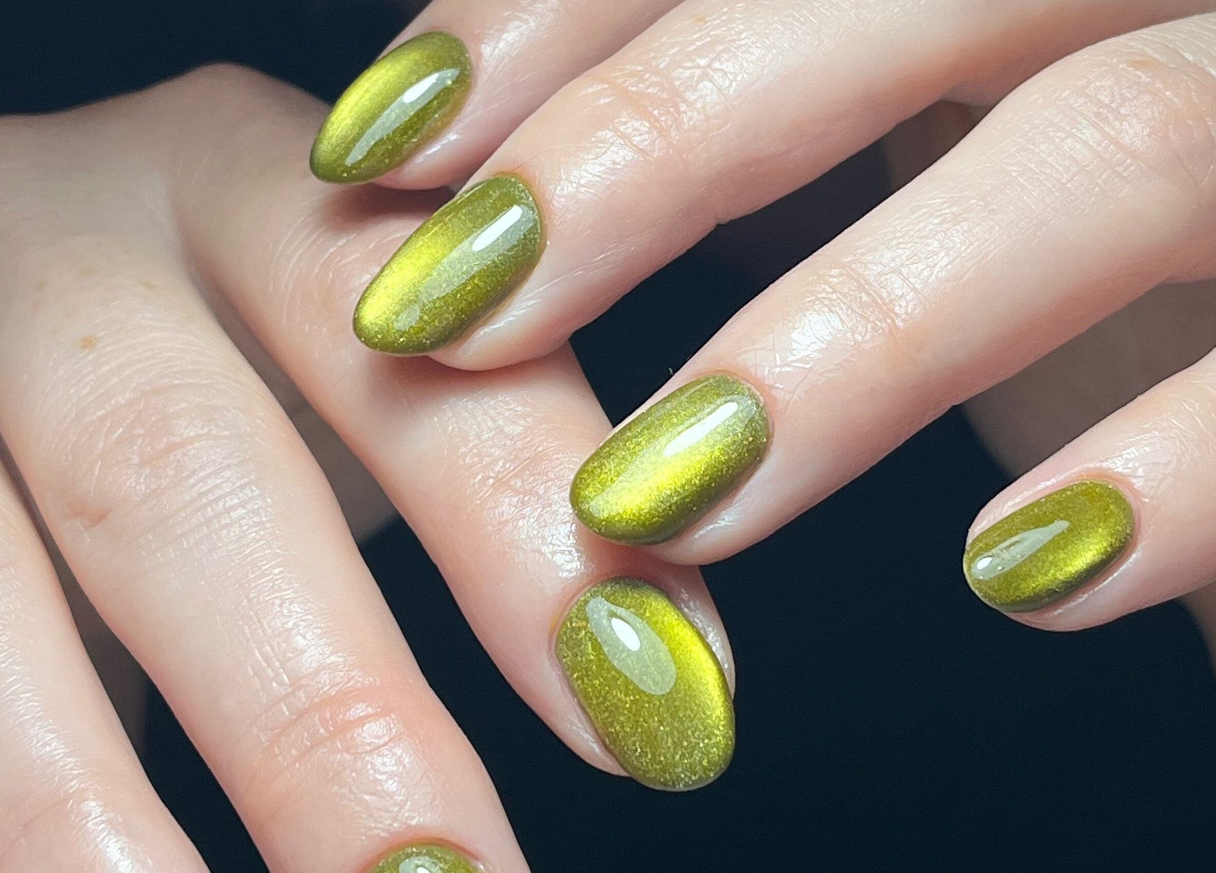 Green gel nails manicure at Claws By Clayre, showcasing elegant shine in Glasgow, Scotland, GB.