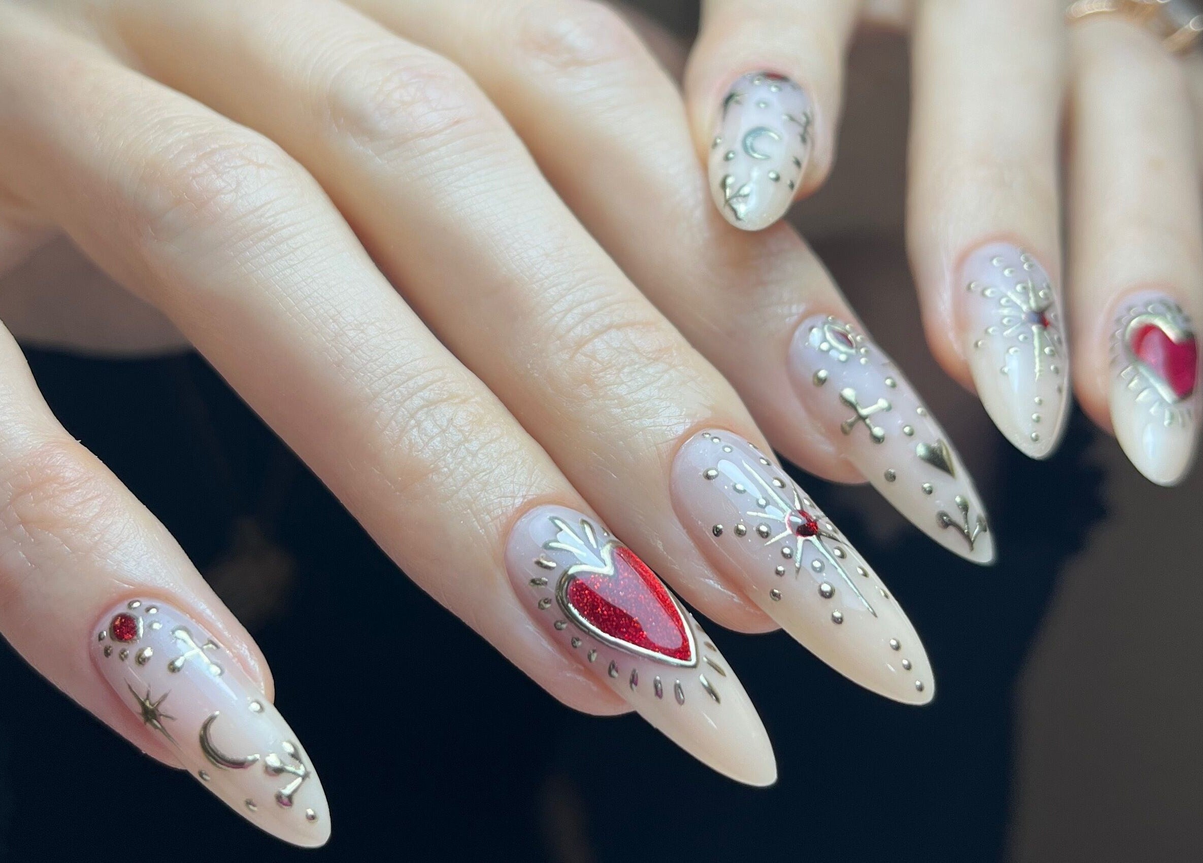 Intricate nail art from Claws By Clayre in Glasgow, Scotland, GB showcasing detailed heart and moon designs.