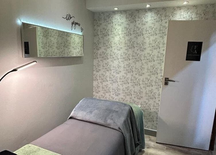 Relaxing treatment room at Faithful Aesthetics, Pretoria, Gauteng, ZA, with cozy bed and soft lighting.