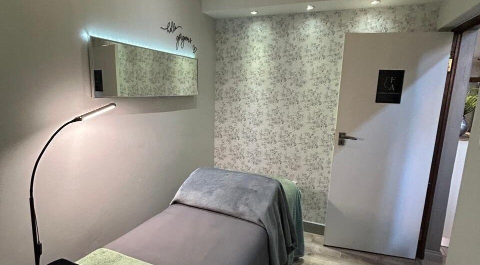 Relaxing treatment room at Faithful Aesthetics, Pretoria, Gauteng, ZA, with cozy bed and soft lighting.