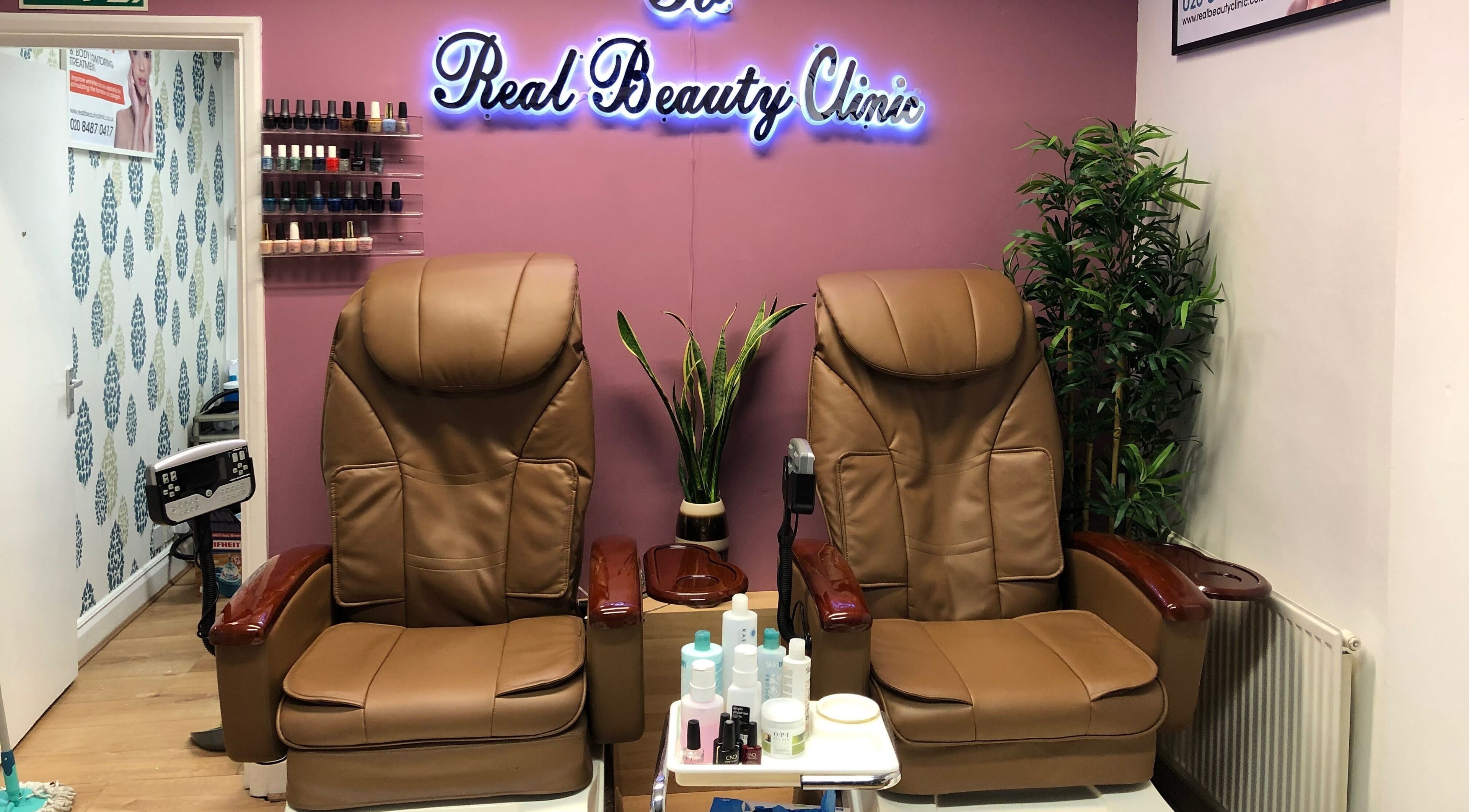 Luxurious pedicure chairs at Real Beauty, Hampton, England, GB, with nail polish display and relaxing ambiance.
