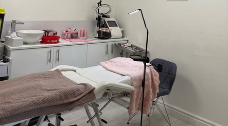 Treatment room at Rosa Aesthetics Apsley, Hemel Hempstead, featuring a cozy recliner and modern equipment.