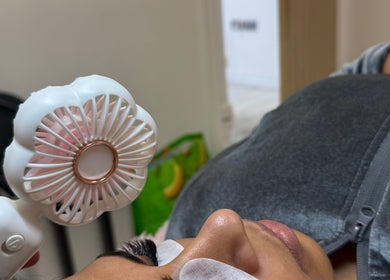 Facial treatment at Rosa Aesthetics Apsley, Hemel Hempstead using handheld fan. Hemel Hempstead, England, GB.
