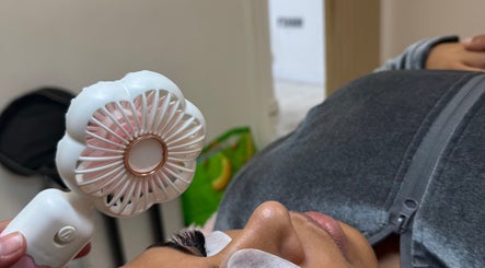 Facial treatment at Rosa Aesthetics Apsley, Hemel Hempstead using handheld fan. Hemel Hempstead, England, GB.
