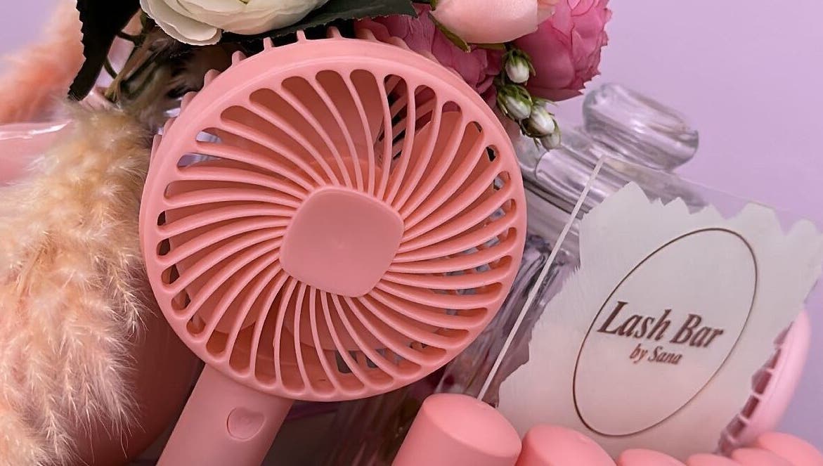 Elegant pink fan and florals at Lash Bar by ST, Birmingham, England, GB showcasing beauty ambiance.