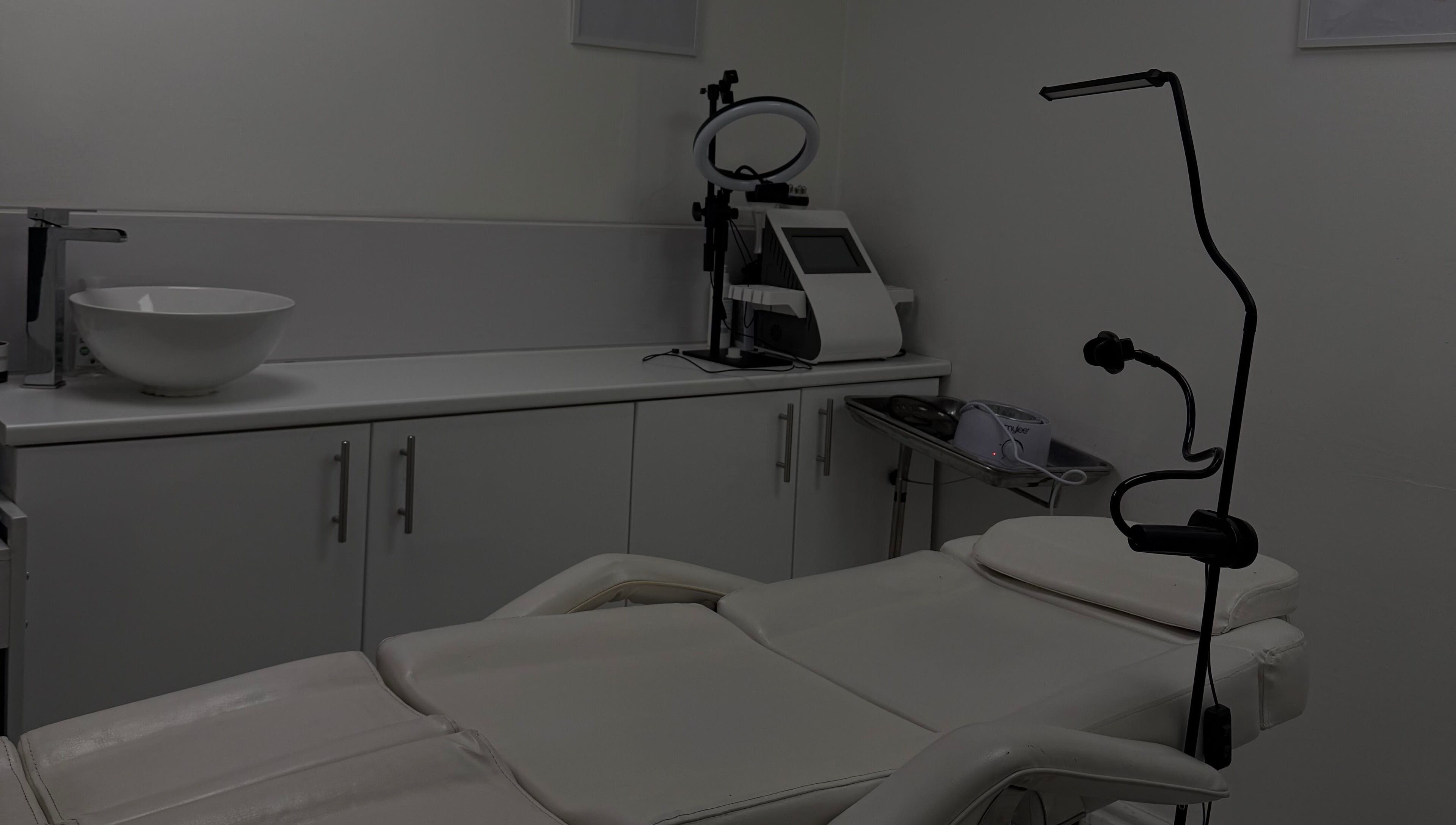 Modern treatment room at Home in Hemel Hempstead, England, GB with a comfortable spa bed and sleek equipment.