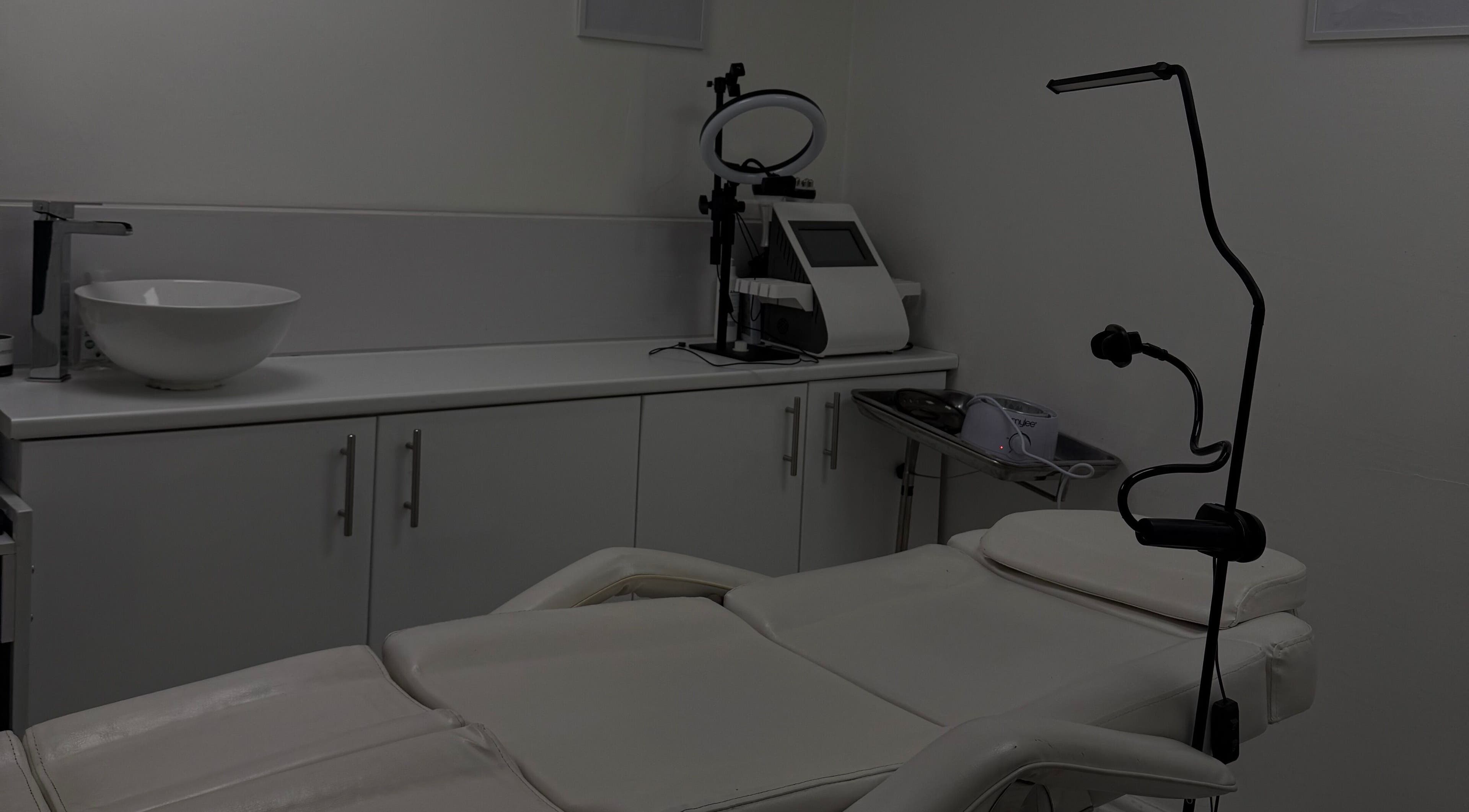 Modern treatment room at Home in Hemel Hempstead, England, GB with a comfortable spa bed and sleek equipment.