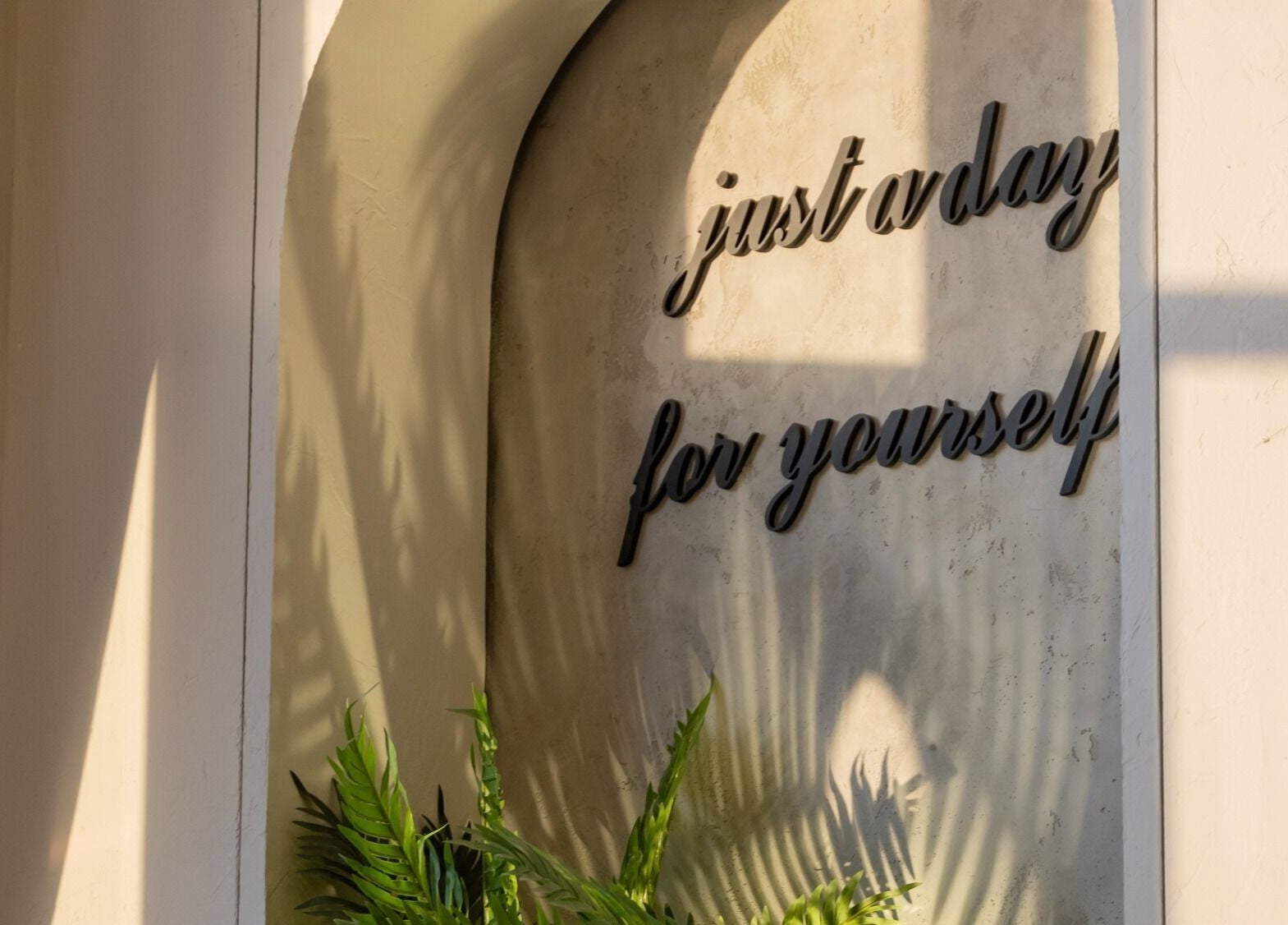 Wall art at Joyous Hands Spa, Riyadh with 'just a day for yourself'.