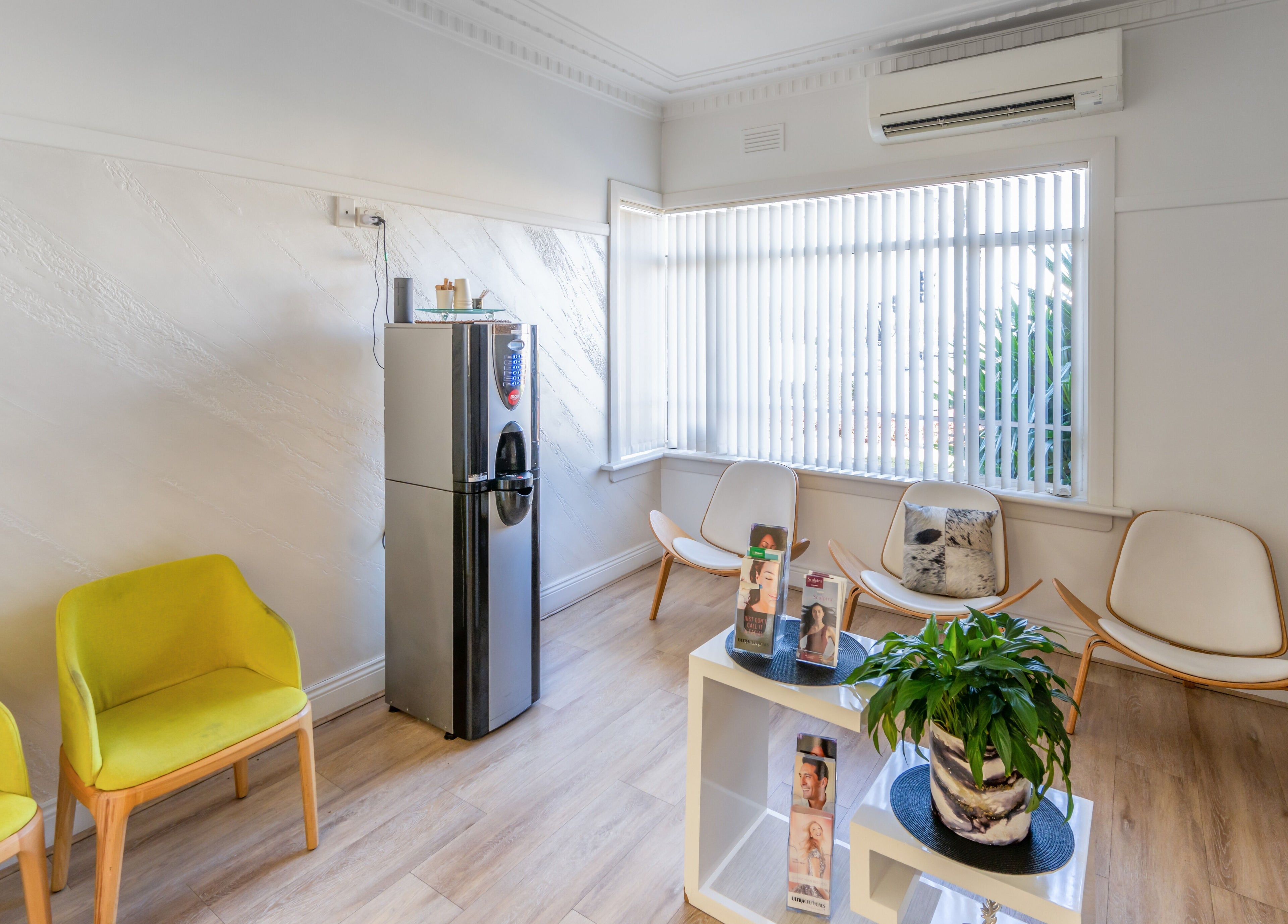 Serene waiting area at My Skinic in Melbourne, Victoria, AU with modern chairs and natural lighting.