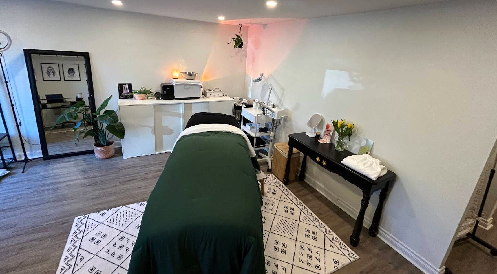 Elegant treatment room at Glow Studio Skin & Beauty, Hamilton, Ontario, CA with a massage table and decor.