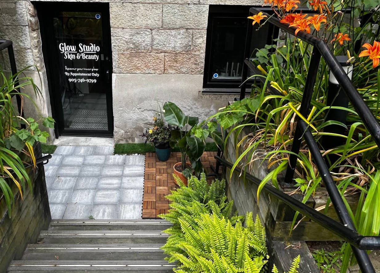 Entrance to Glow Studio Skin & Beauty, lush plants and flowers, located in Hamilton, Ontario, CA.
