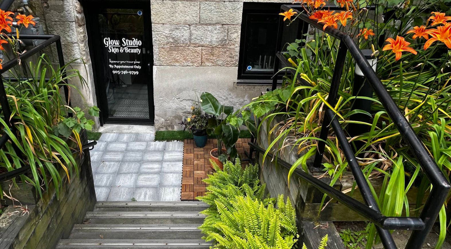 Entrance to Glow Studio Skin & Beauty, lush plants and flowers, located in Hamilton, Ontario, CA.