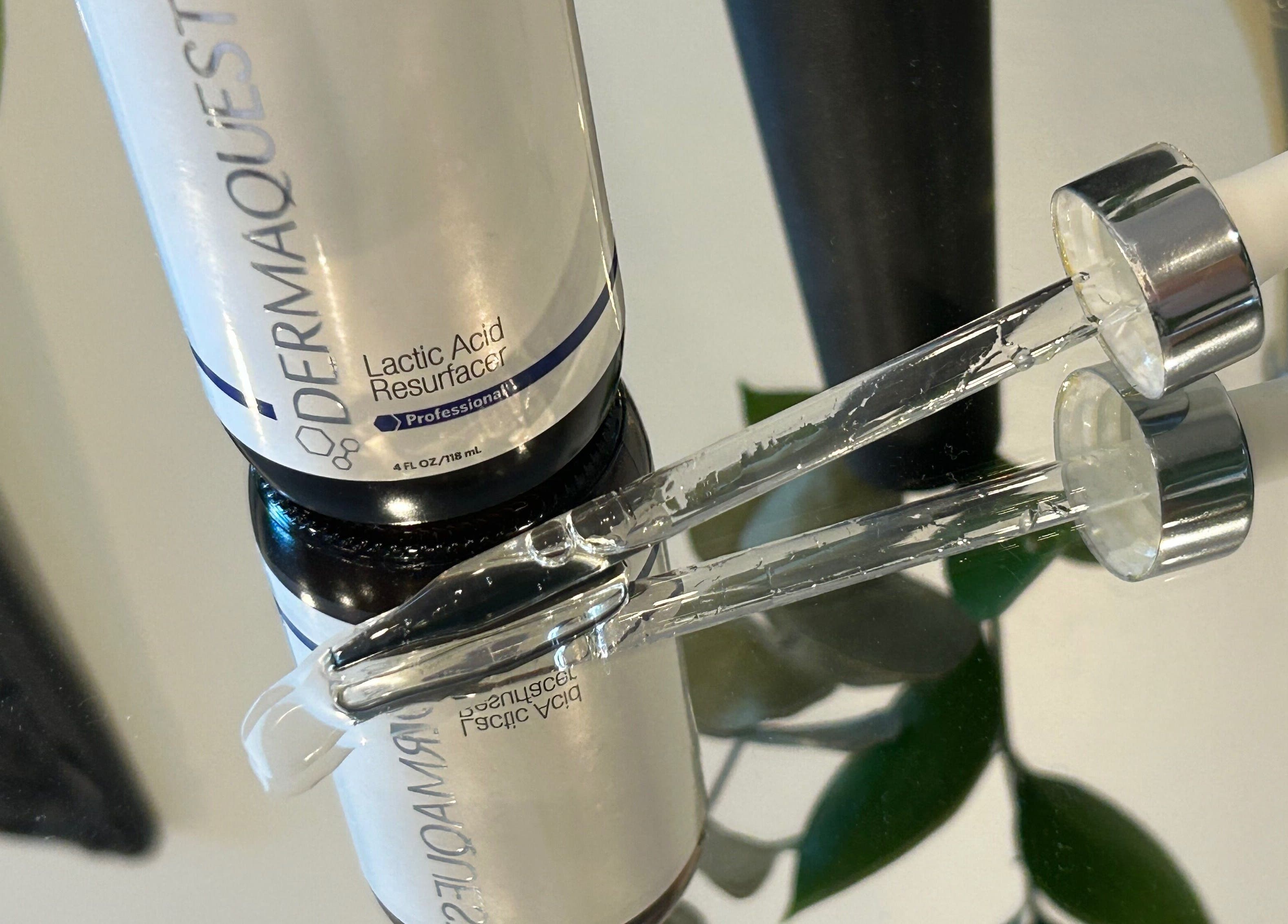 Lactic Acid Resurfacer serum at Glow Studio Skin & Beauty, Hamilton, Ontario, CA reflecting on a mirror.