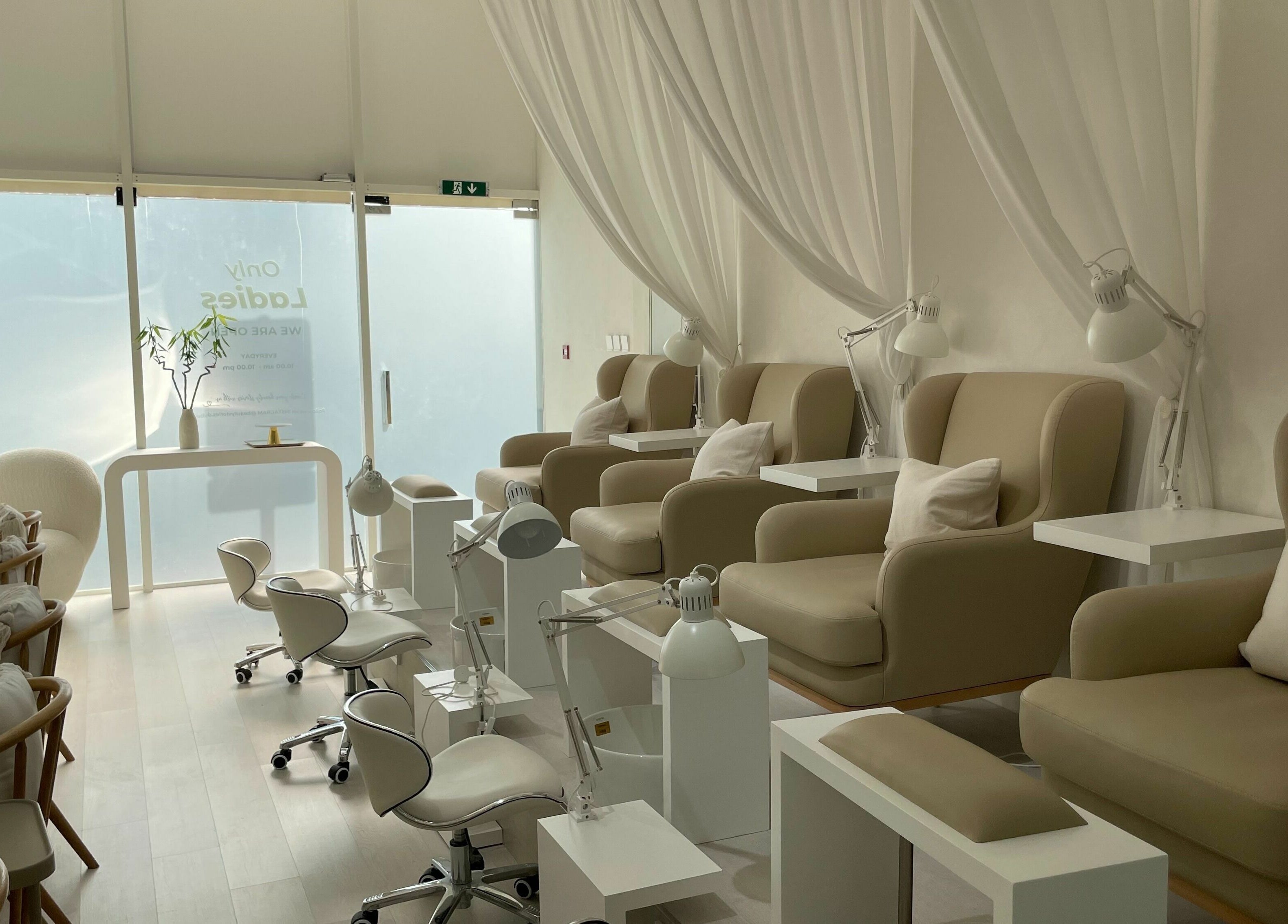 Elegant nail spa interior at Beauty Stories Dmcc, Dubai, Dubai, AE, featuring plush chairs and soft lighting.