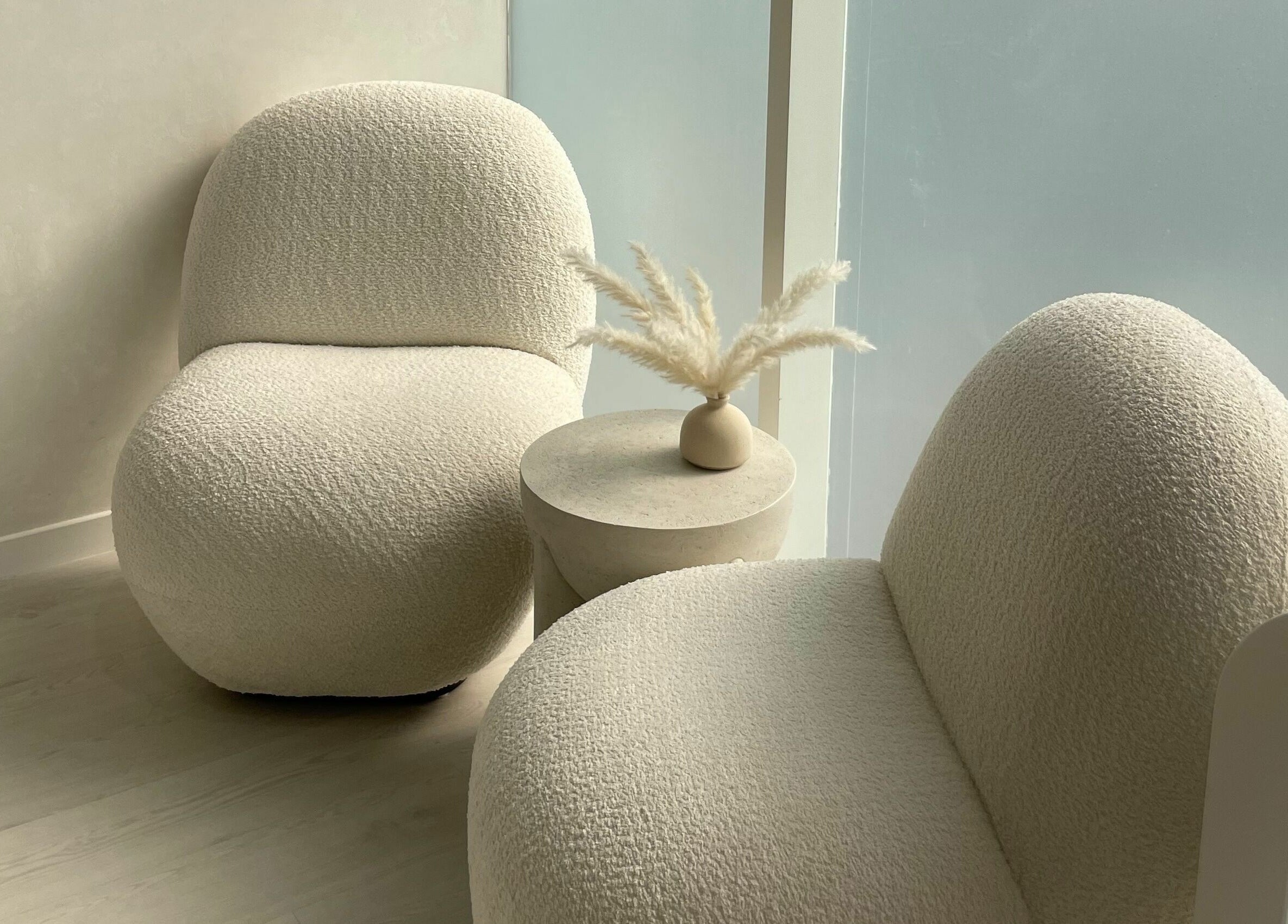 Elegant seating with round chairs and pampas on a table at Beauty Stories Dmcc, Dubai, Dubai, AE.