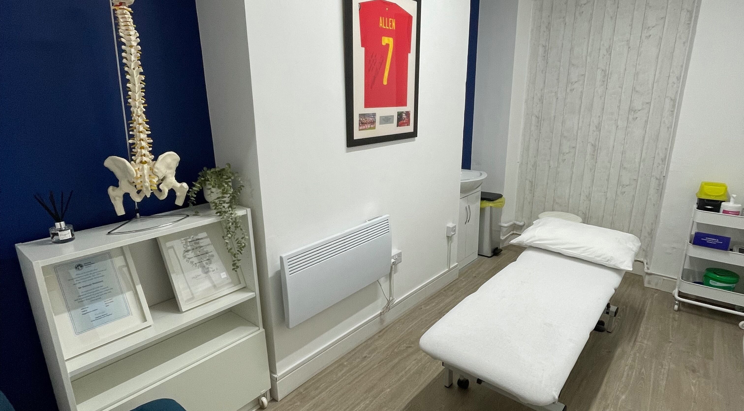 Treatment room at OsteoHub Mumbles, Swansea, Wales, GB with a massage table and decor details.