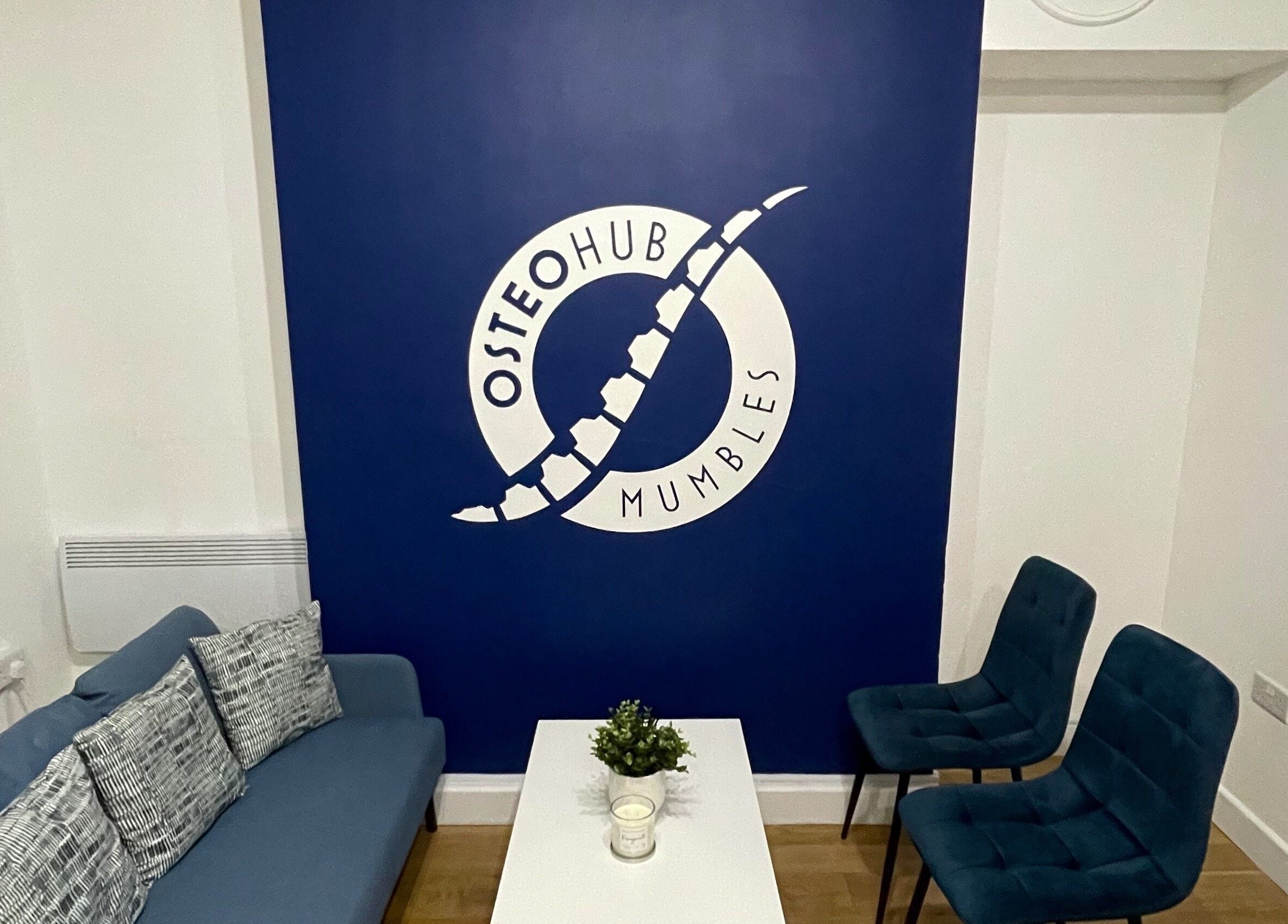 Comfortable seating area at OsteoHub Mumbles in Swansea, Wales, GB with blue decor and modern accents.