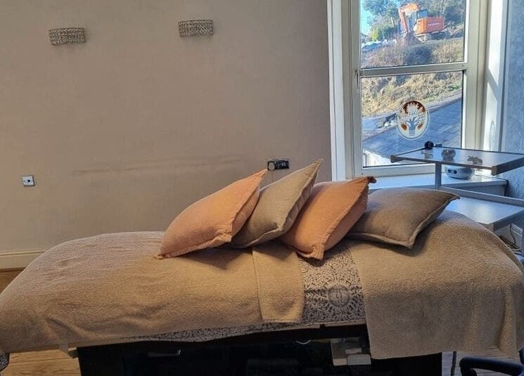 Cozy treatment room at Oaktree Parc Clinic, Birchgrove, Wales, GB with inviting massage bed and relaxing ambiance.
