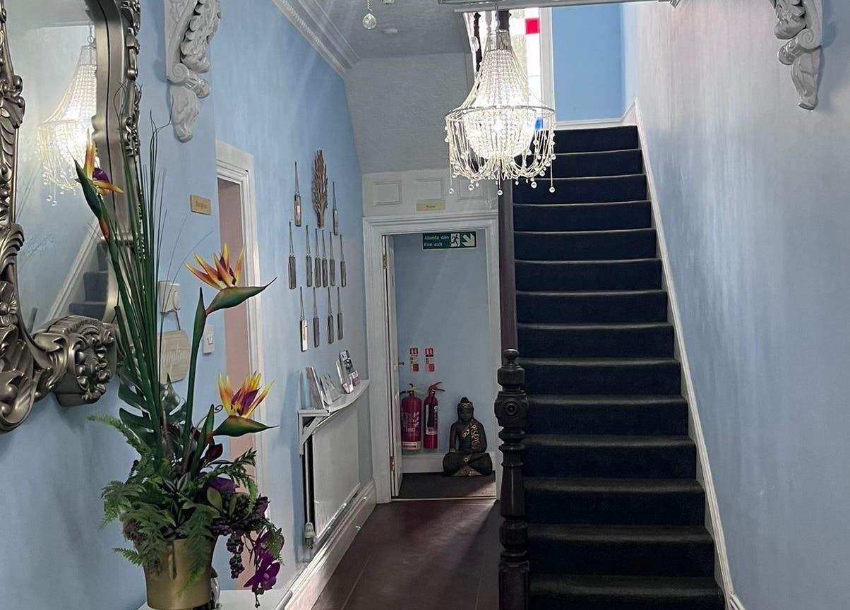Elegant hallway at Oaktree Parc Clinic, Birchgrove, Wales, GB with plush carpet and chandelier.