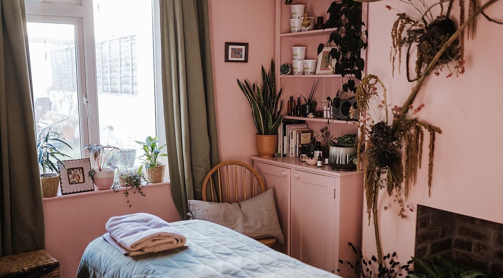 Cozy treatment room at Held - Ritual Skin Therapies in Bristol, England, GB with plants and soft pink decor.