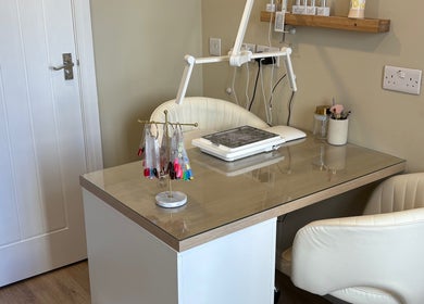 Modern nail station at Charlotte Marie Nails And Beauty, Heysham, England, GB with manicure tools and color samples.