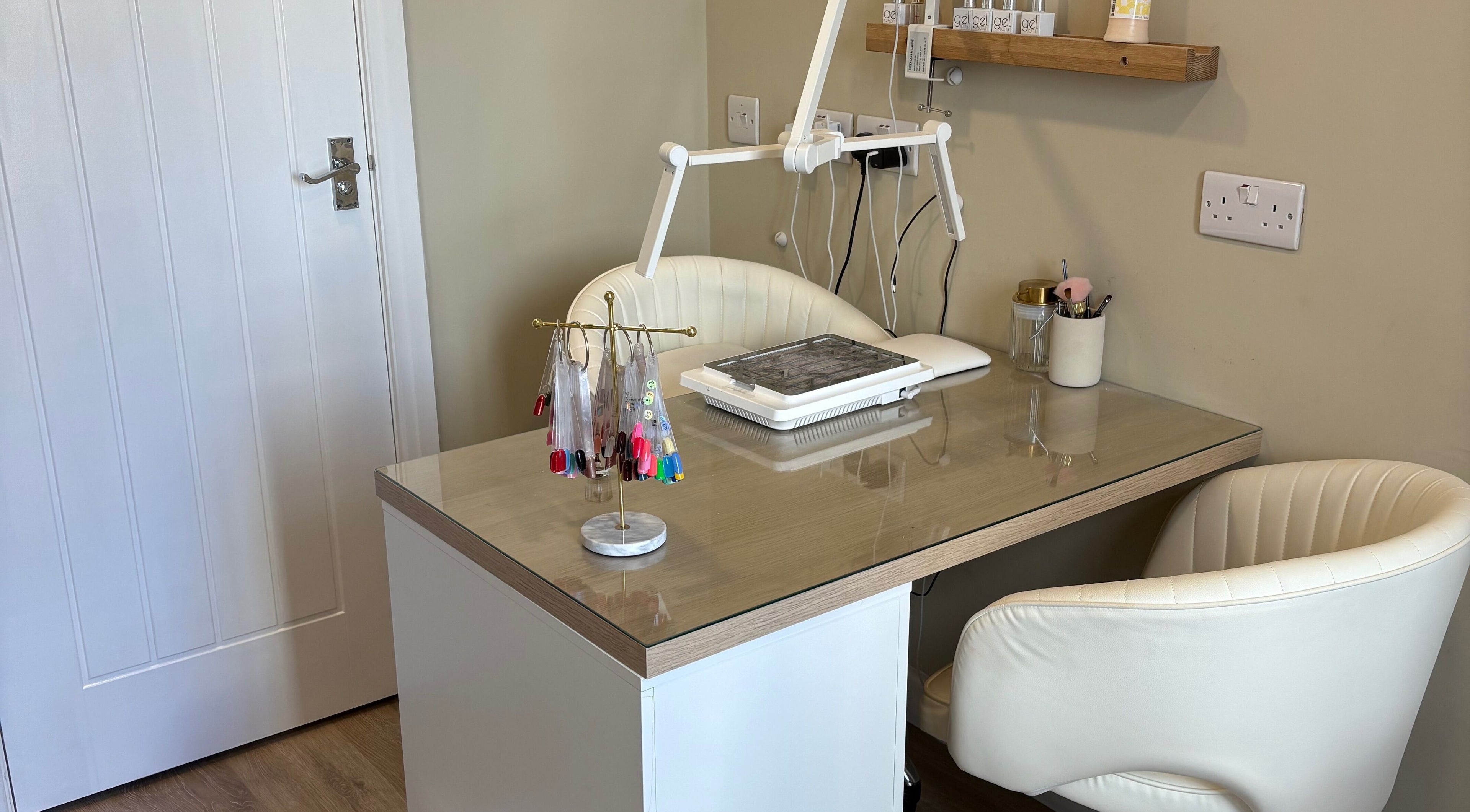 Modern nail station at Charlotte Marie Nails And Beauty, Heysham, England, GB with manicure tools and color samples.