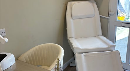Relaxing nail station at Charlotte Marie Nails And Beauty, Heysham, England, GB, featuring a cozy white chair.