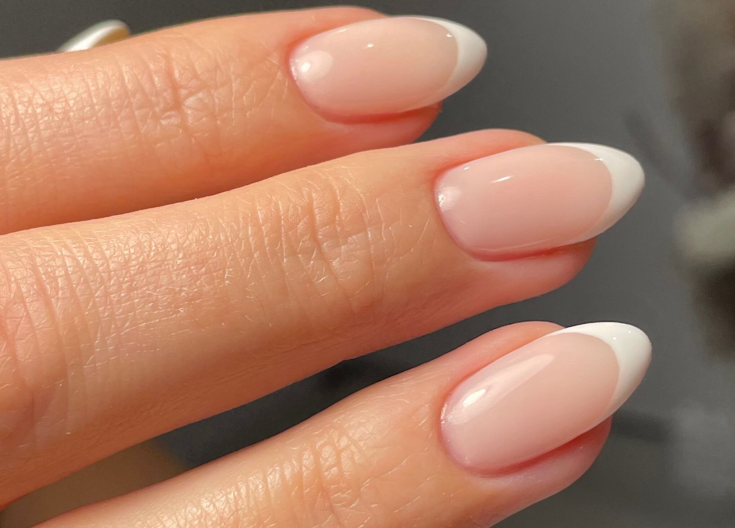 Elegant French manicure at Cure&Co., Chepstow, GB showcasing glossy pastel nails.