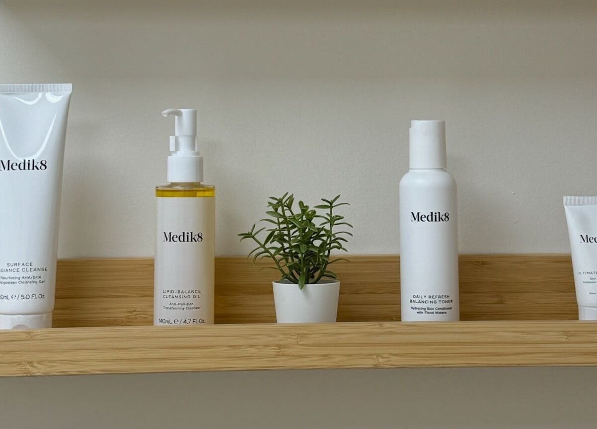 Shelf at Cure&Co. in Chepstow, GB with skincare products and decorative plant.