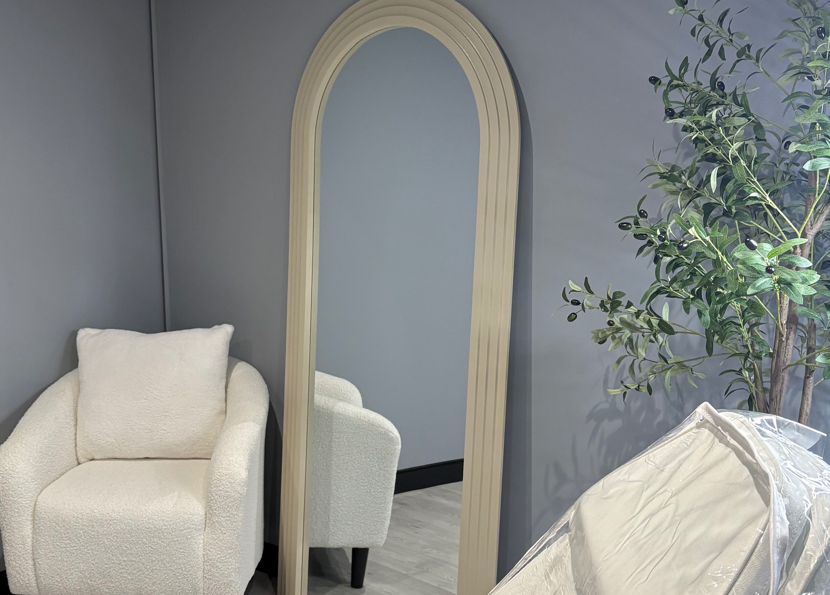 Elegant chair and mirror setup at All About Aesthetics, Fareham, England, GB, featuring soothing decor.