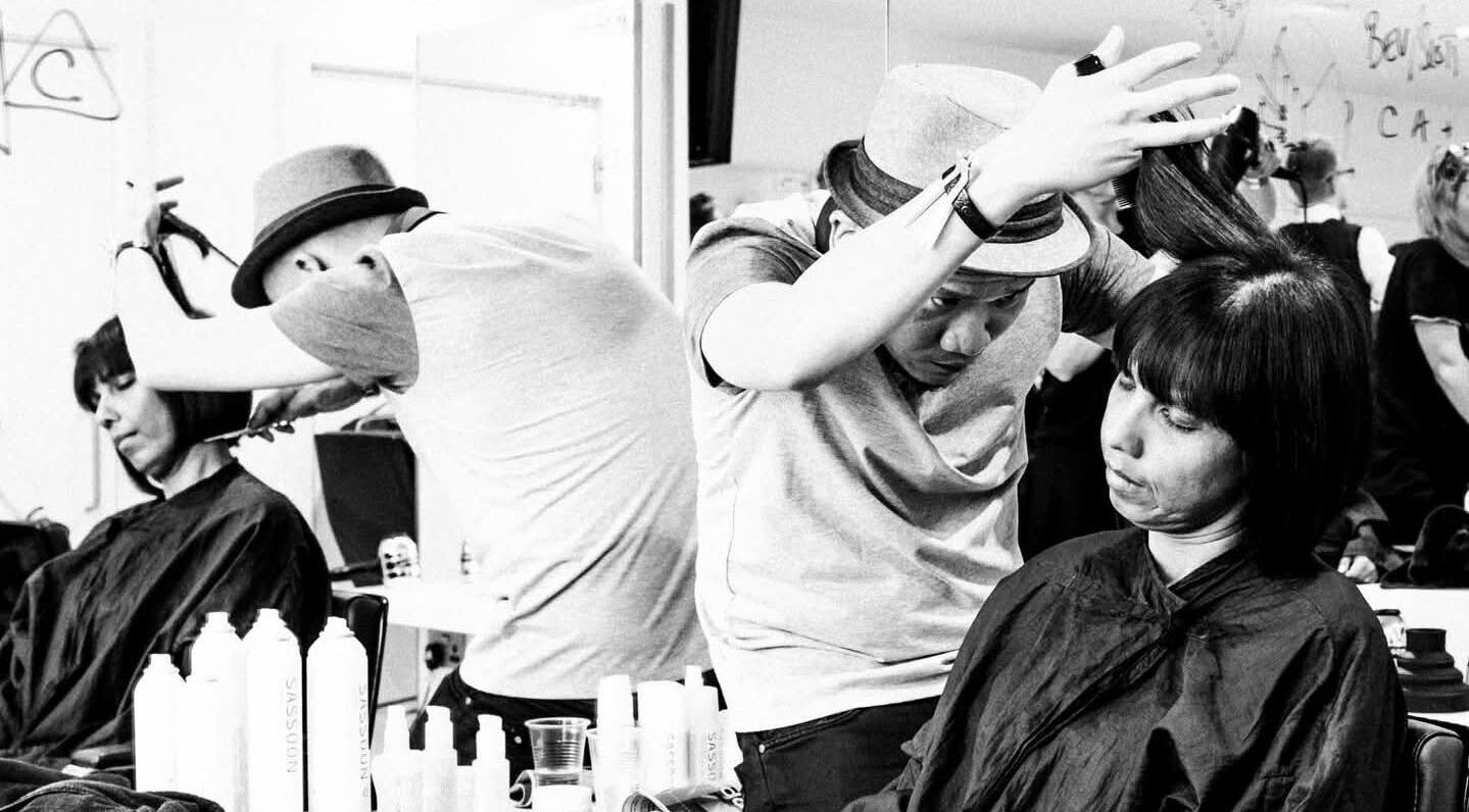 Professional stylist at Bernard Hairdresser in Dublin, County Dublin, IE, expertly cuts a client's hair.