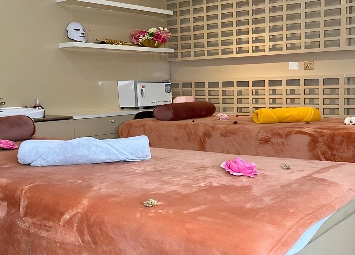 Luxurious spa beds at LIOCA ESTHETICS, SPA & SALON, Lagos, NG, adorned with flowers for a serene experience.