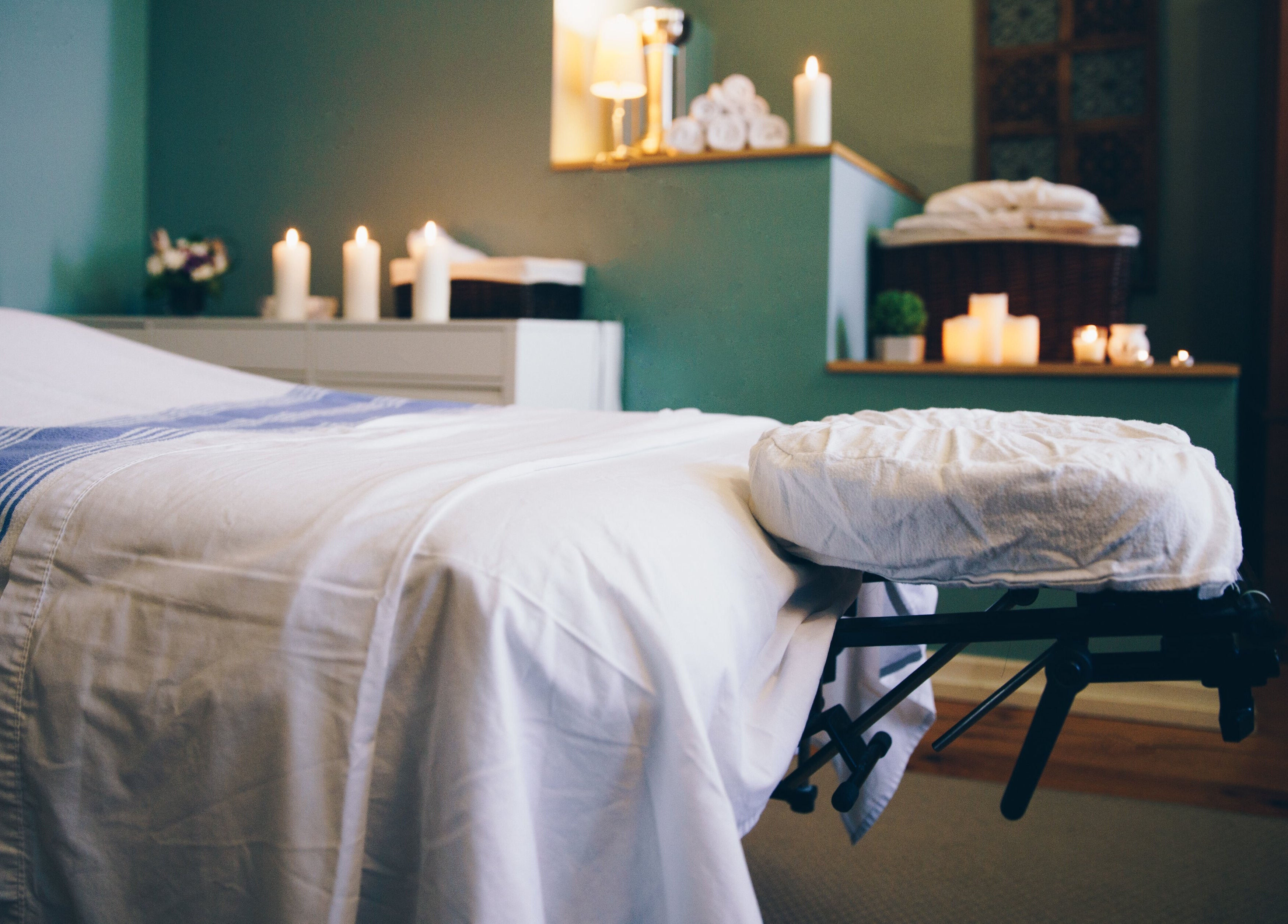 Tranquil massage room at LIOCA ESTHETICS, SPA & SALON in Lagos, Lagos, NG with lit candles and neat linens.