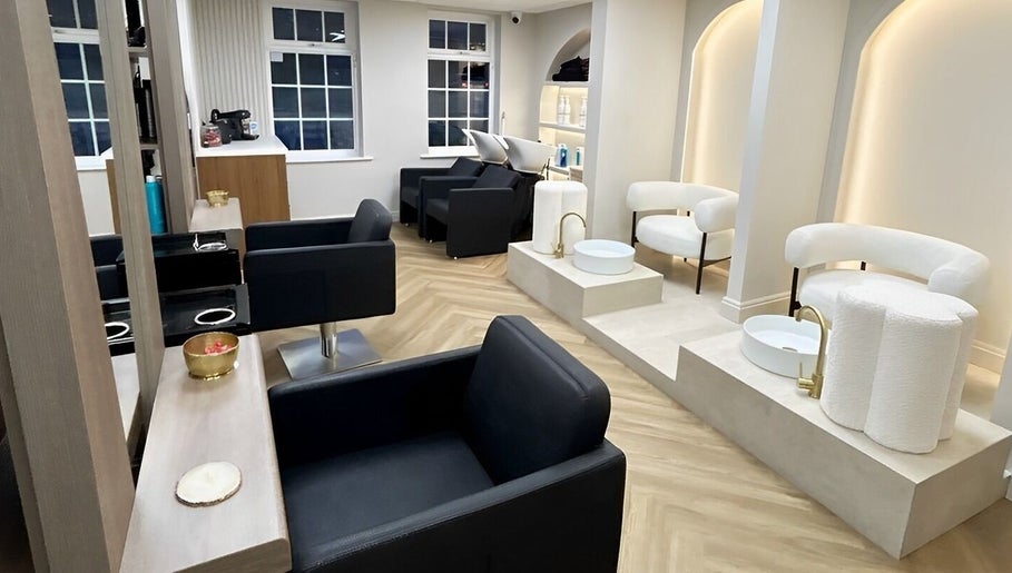 Elegant salon chairs and washing stations at Masee Rose Hair in Manchester, England, GB.