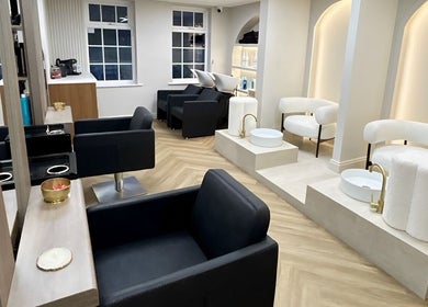 Elegant salon chairs and washing stations at Masee Rose Hair in Manchester, England, GB.