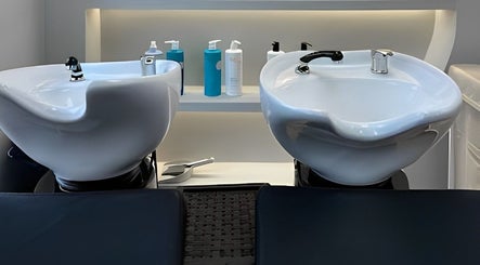 Modern wash stations at Masee Rose Hair, Manchester, England, GB, featuring sleek salon design.