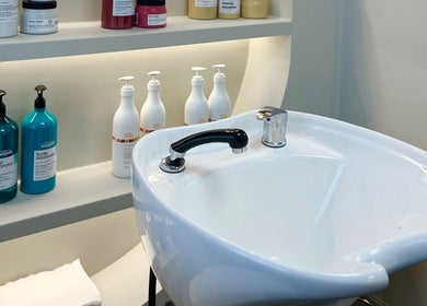 Modern wash station at Masee Rose Hair, Manchester, England, GB with premium hair products displayed.