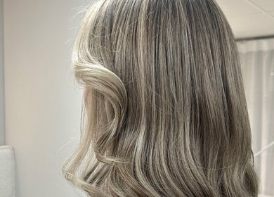 Smooth blonde waves styled at Masee Rose Hair in Manchester, England, GB.